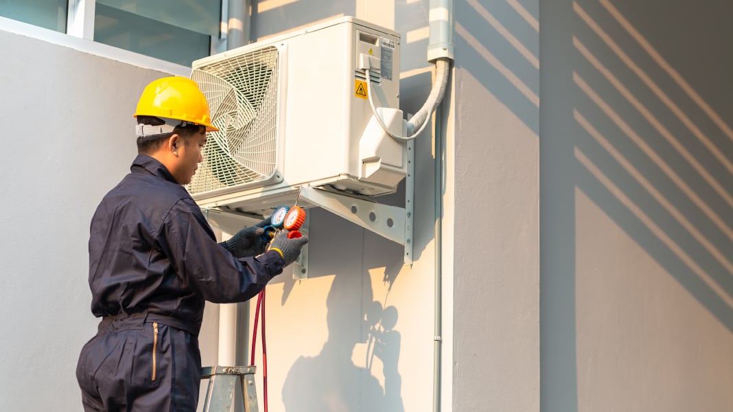 Man servicing AC Unit