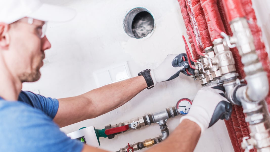 Plumber checking pipe work.